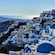 Mediterranean style buildings with domed roofs on a hillside overlooking the sea